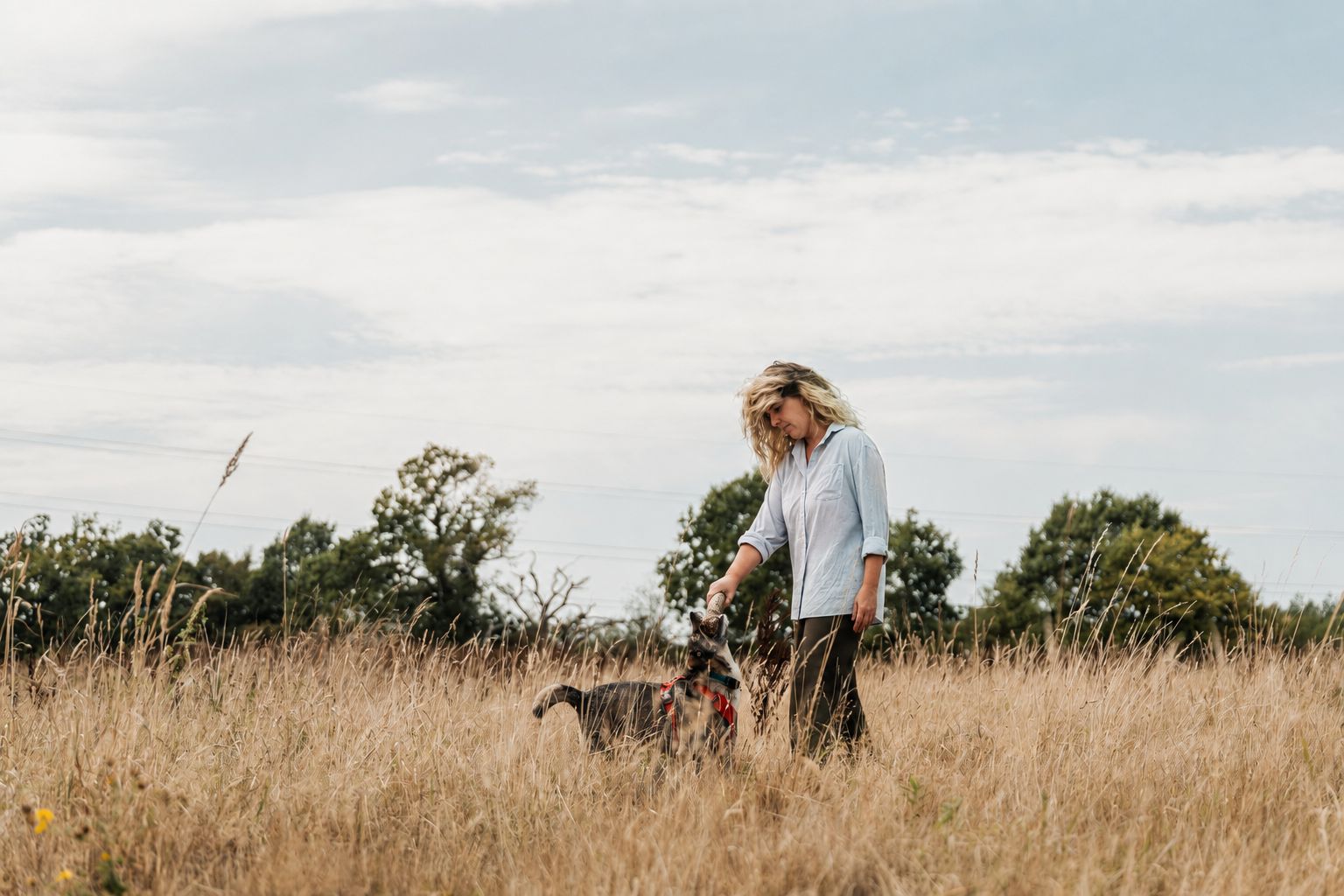 Laura with a dog in a meadow