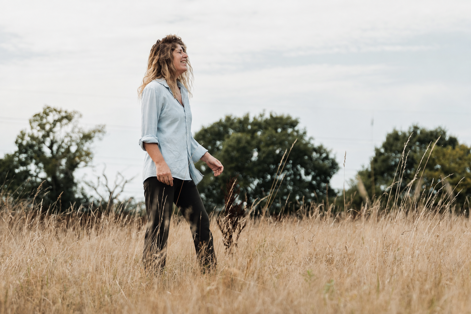 Laura walking through a meadow near Canterbury
